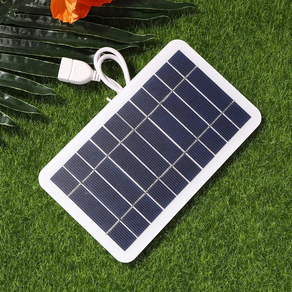 2W solar panel — panel and USB output on grass