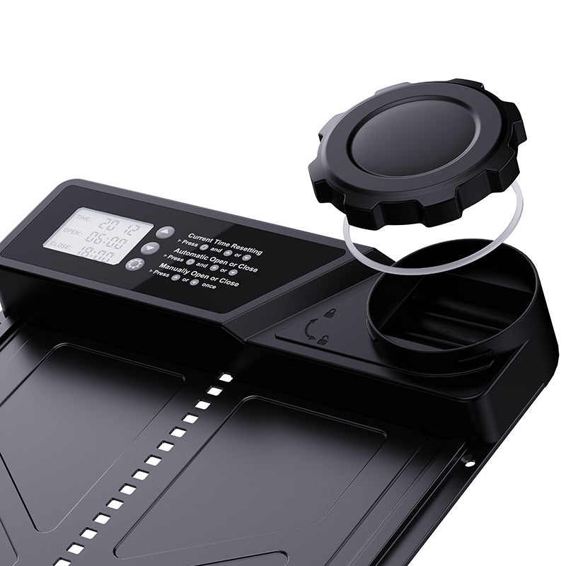 Coop door controller close-up with circular cap, seal ring and display