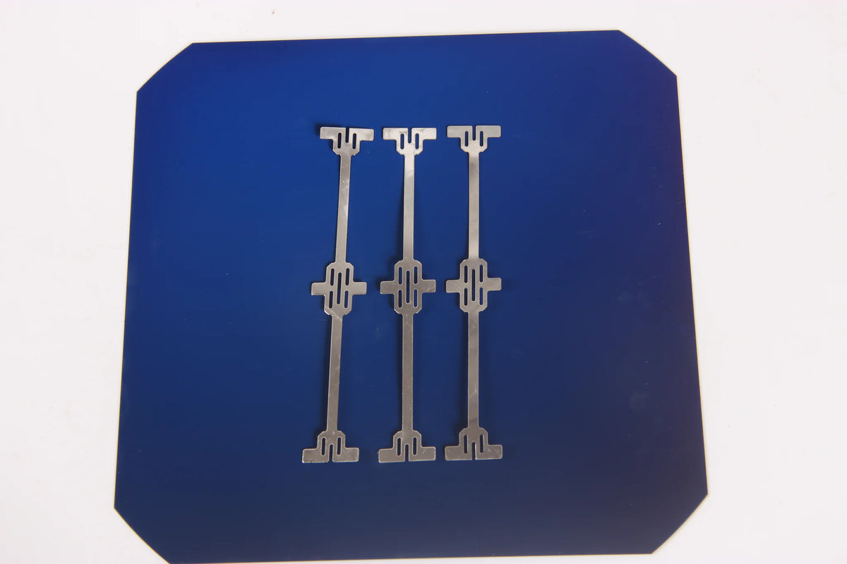 Three C60 dog bone tabbing wires positioned on a solar cell