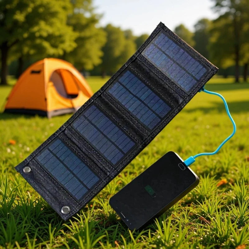 Four-panel USB solar charger with phone at a campsite