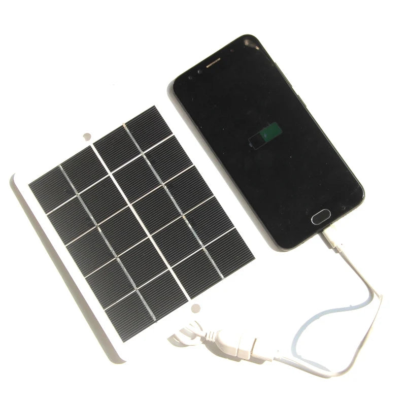 Solar panel charging a USB phone; phone not included