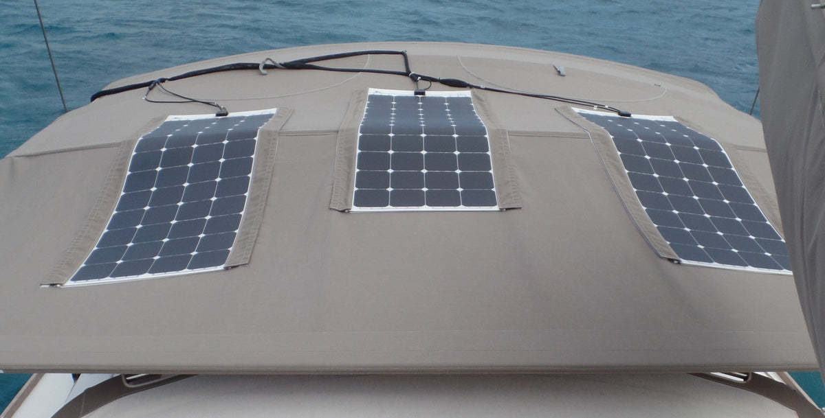 Three flexible solar panels following the curve of a boat bimini top