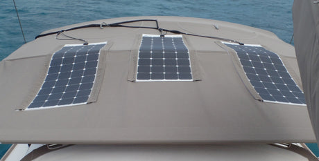 Three flexible solar panels following the curve of a boat bimini top