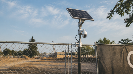 Solar panel and 4G camera mounted on construction site fence post