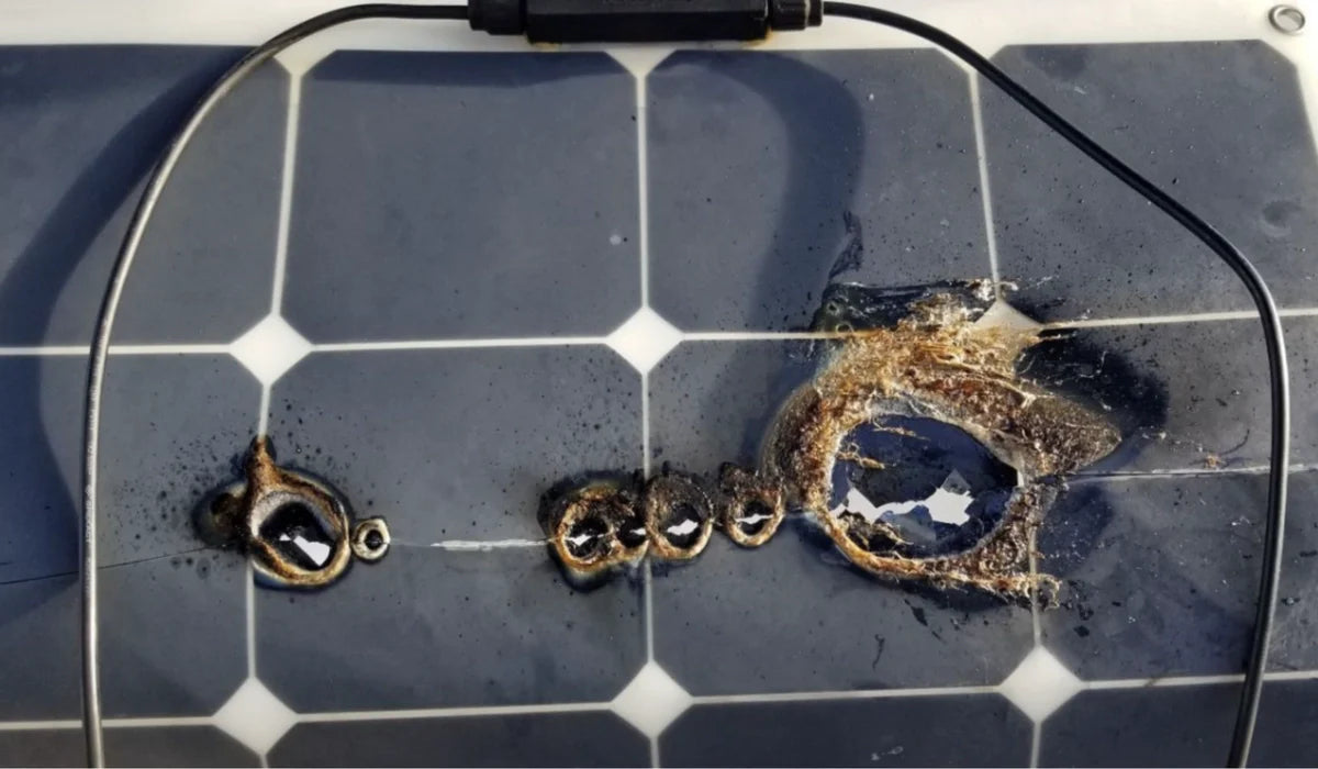 severe hotspot burn damage on flexible solar panel caused by cell overheating and material failure