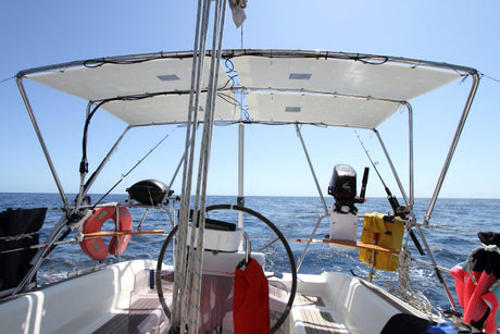 Flexible solar panel installation on a sailboat bimini top over water