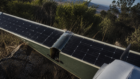 Fixed-wing RC glider with SunPower IBC solar cells mounted on flat wing surface in outdoor sunny setting