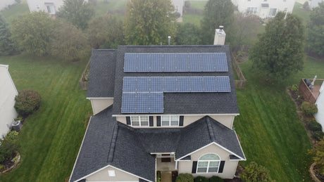 Rooftop solar panel array on a suburban home illustrating how many panels power a house