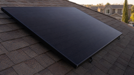 Close-up of a black IBC solar panel with no front busbars on a residential roof