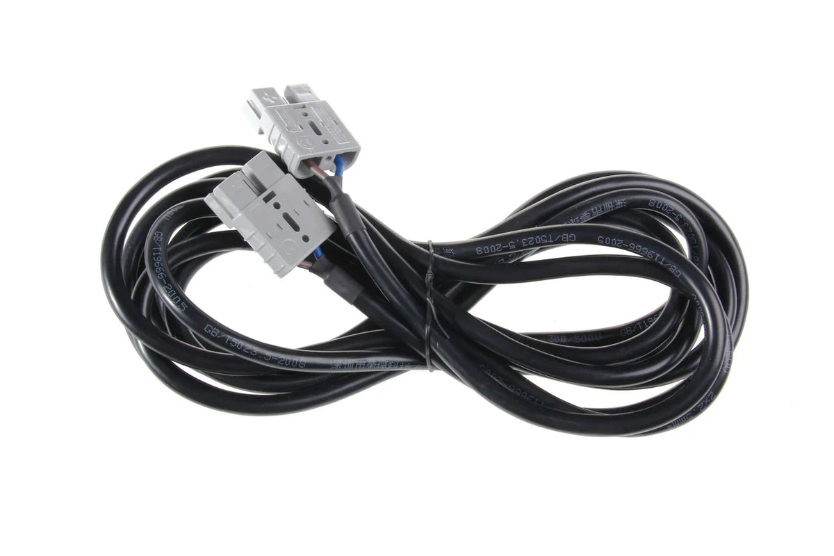 User-supplied photograph: coiled black cable assembly with two gray connector housings