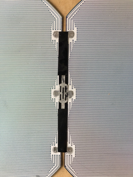 Macro shot of interconnected solar cell circuit and soldering points