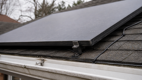 Close-up of a black IBC solar panel with no front busbars installed on a roof