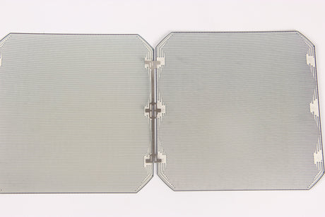 Rear side of two semi-square monocrystalline solar cells joined by a metal interconnect