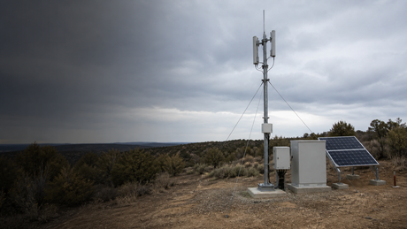 An off-grid telecom site with a solar array powering wireless network equipment.