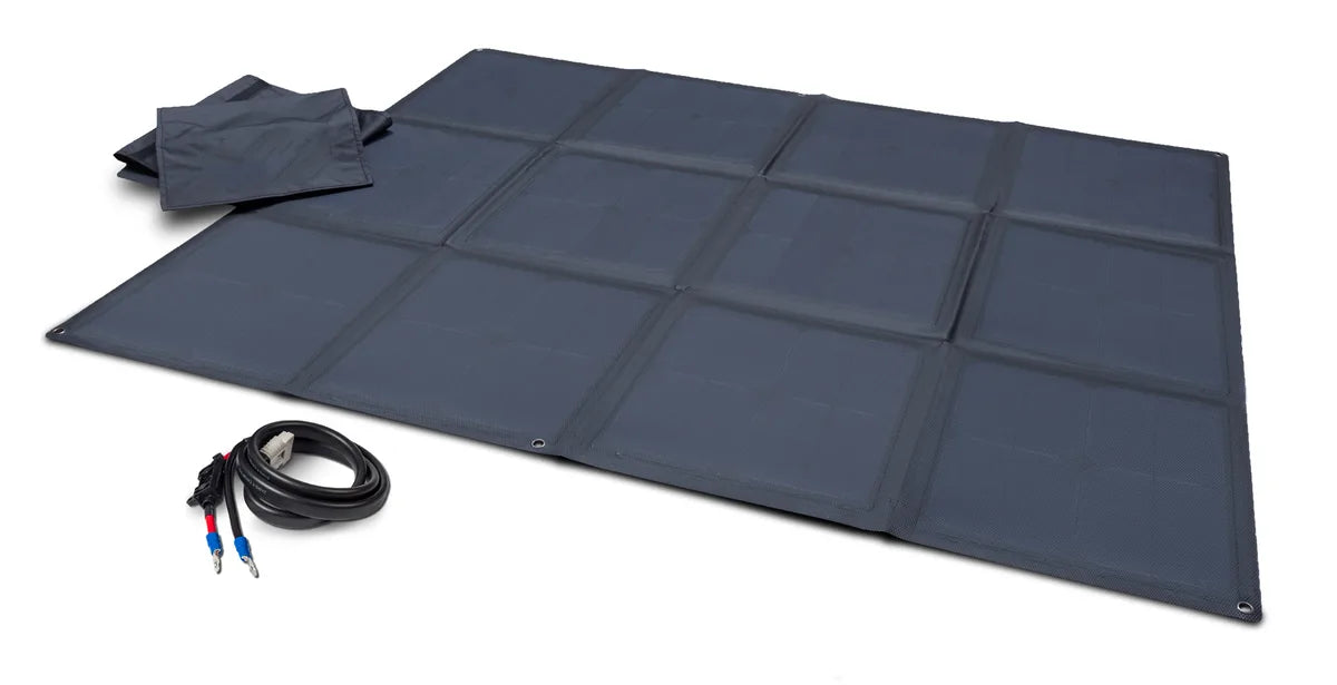 Unfolded solar blanket beside a carry pouch and a separate coiled cable