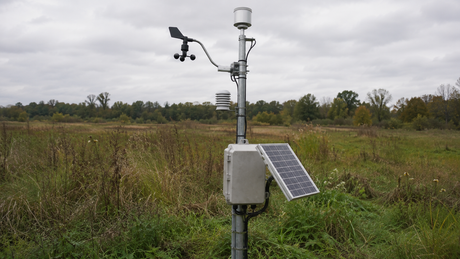 Environmental monitoring sensor station powered by a small solar panel in an open field
