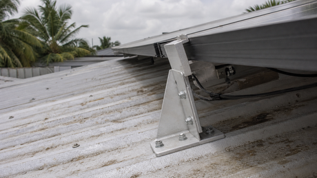 Close-up of anodized aluminum solar panel brackets mounted on a metal roof