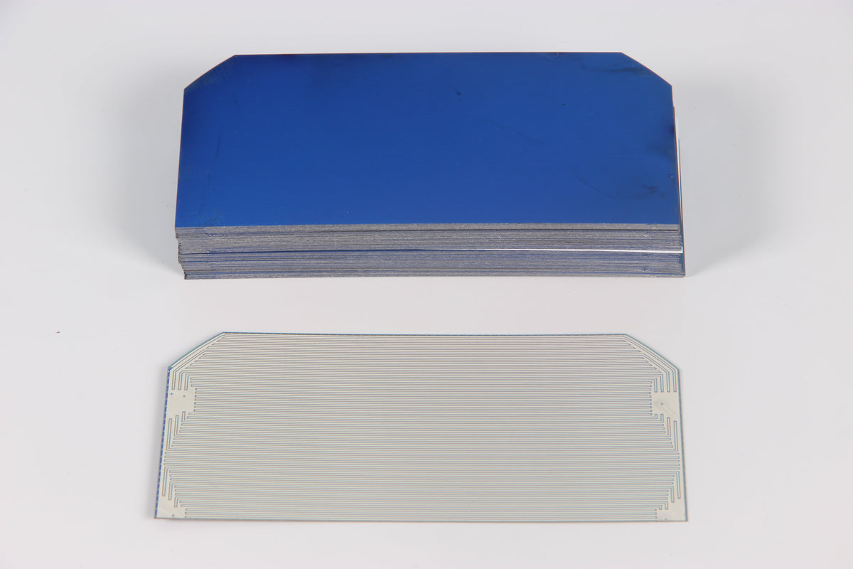 Stack of cut solar cells on a plain white studio background