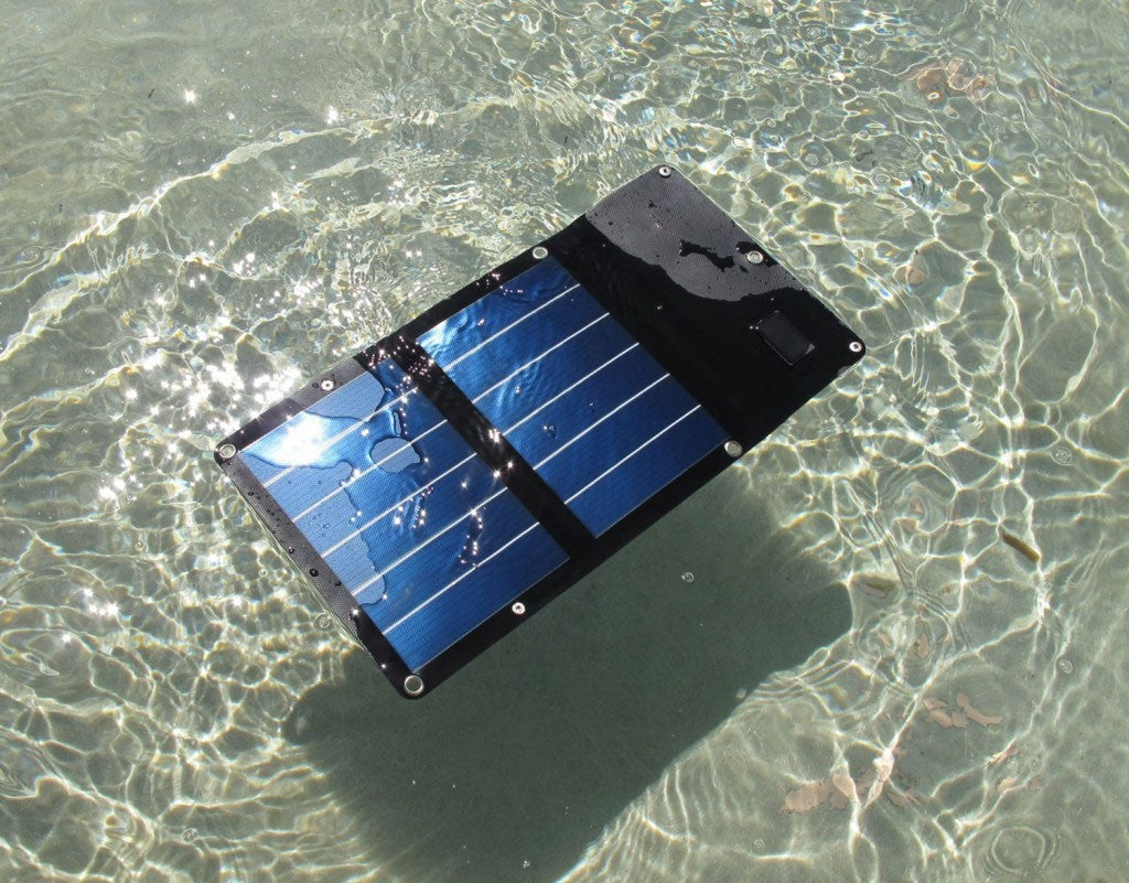 Waterproof mini solar panel floating in clear shallow water
