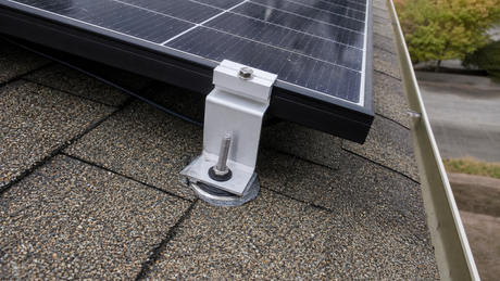 Four-piece Z-bracket set installed on an asphalt shingle roof with stainless hanger bolts and sealed washers