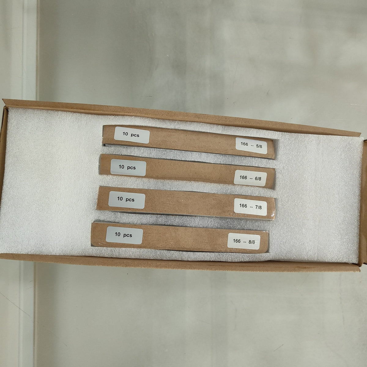 One-eighth-cut 166 mm solar cell strips 5/8 to 8/8 in their own foam slots inside the shipping carton