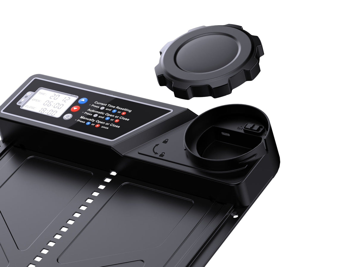 Close-up of coop door digital controls and open round housing cap