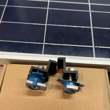 Black solar panel end clamps installed on mounting channels