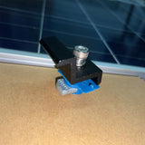 Black Unistrut end clamps securing a solar panel frame