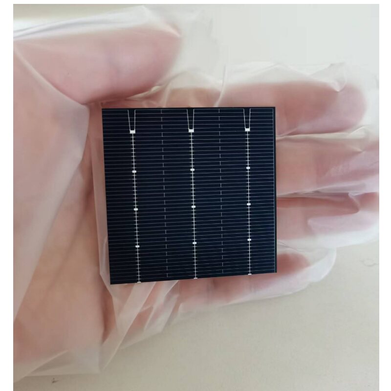 Compact 52mm x 52mm bifacial PERC solar cell resting on a gloved hand
