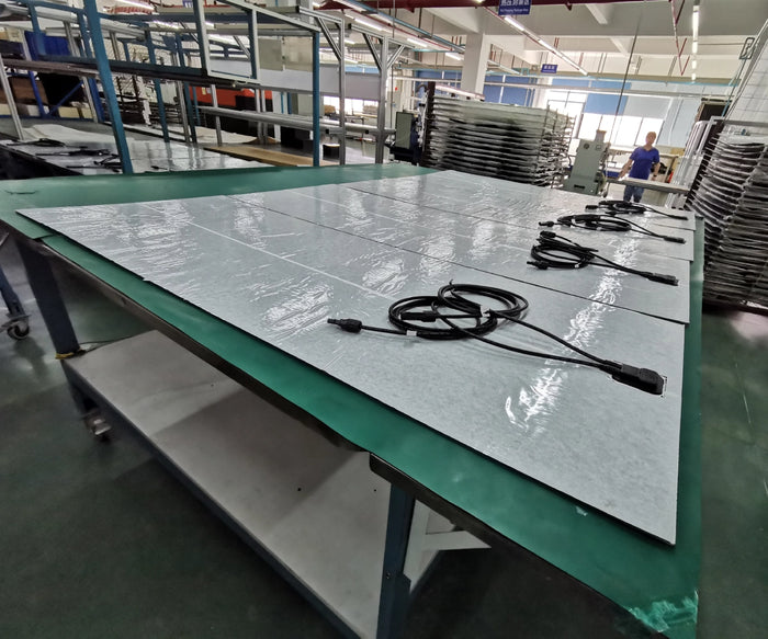 flexible solar panels with backsheet and MC4 cables arranged on production table