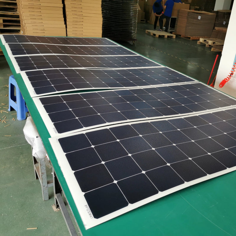 flexible solar panels laid out on workbench for quality inspection