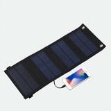 Four-section solar charger connected to a phone; phone not included