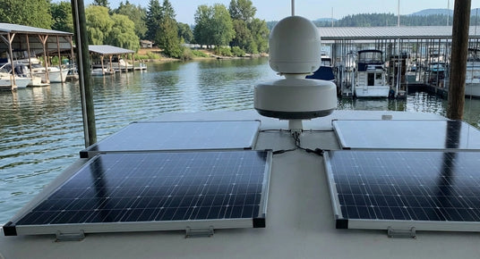 marine solar panels mounted on boat roof near harbor