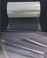 PET solar panel backsheet roll partly unrolled on a dark background