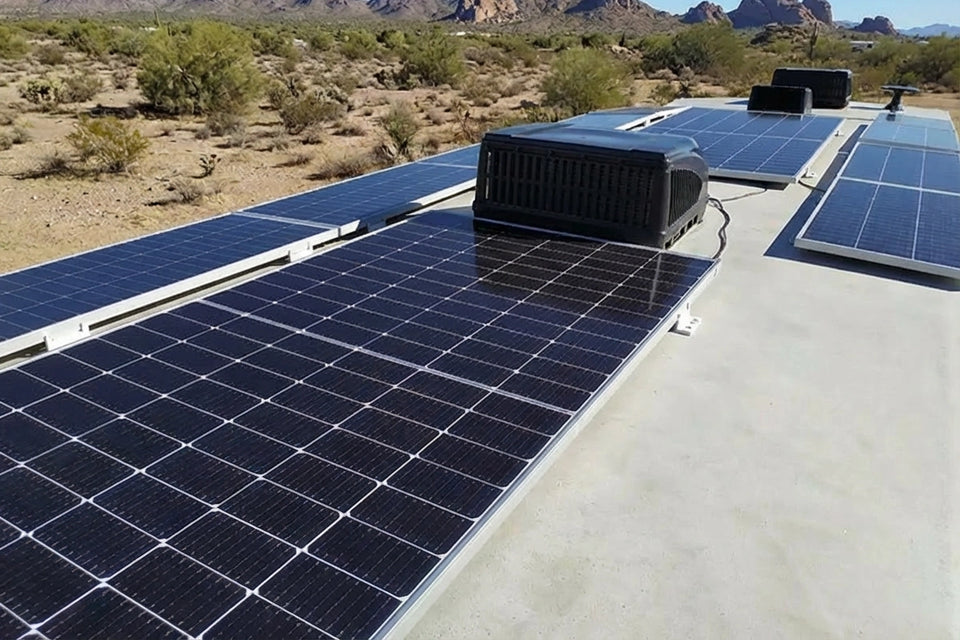 Large solar array mounted on an RV roof for off-grid power in a desert setting.