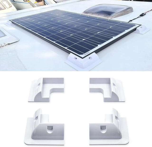 White solar panel corner mounts supporting a framed module on an RV roof