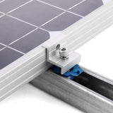 Silver solar panel end clamp securing a framed module to strut channel