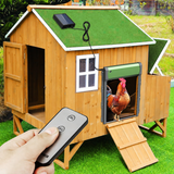 Green automatic coop door on a wooden chicken house with a solar panel and handheld remote
