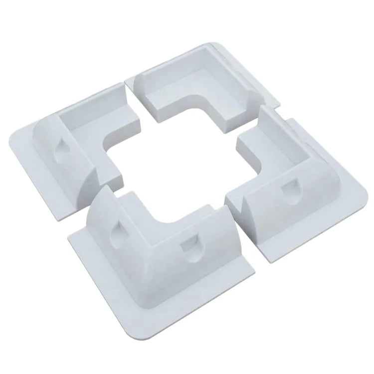 Four white ABS solar panel corner mounts arranged as one set