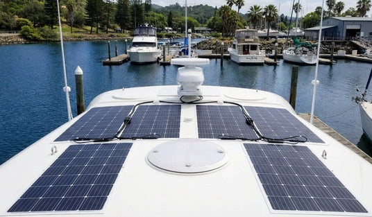 flexible solar panels on yacht roof at marina dock
